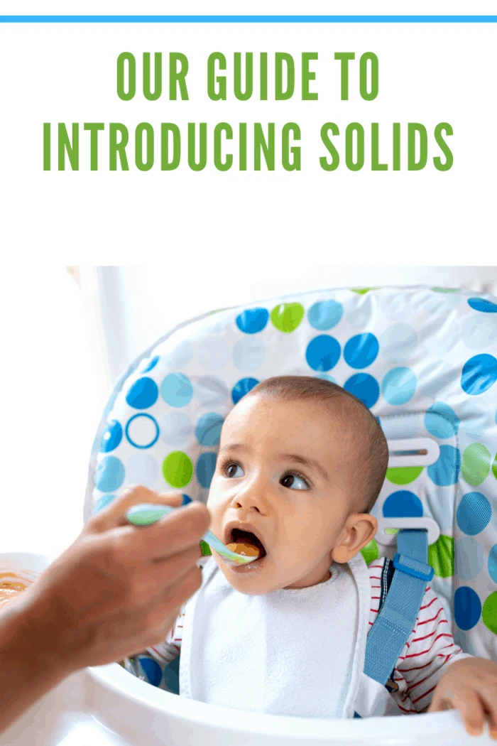 Caring parent taking responsibility of introducing her child to solid foods and teaching him that milk is not the only food in the world