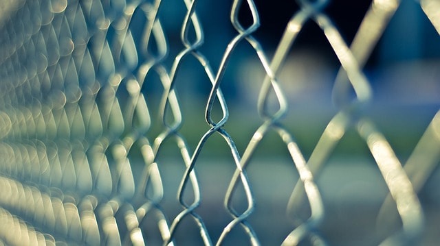 chain link fence depicting prison
