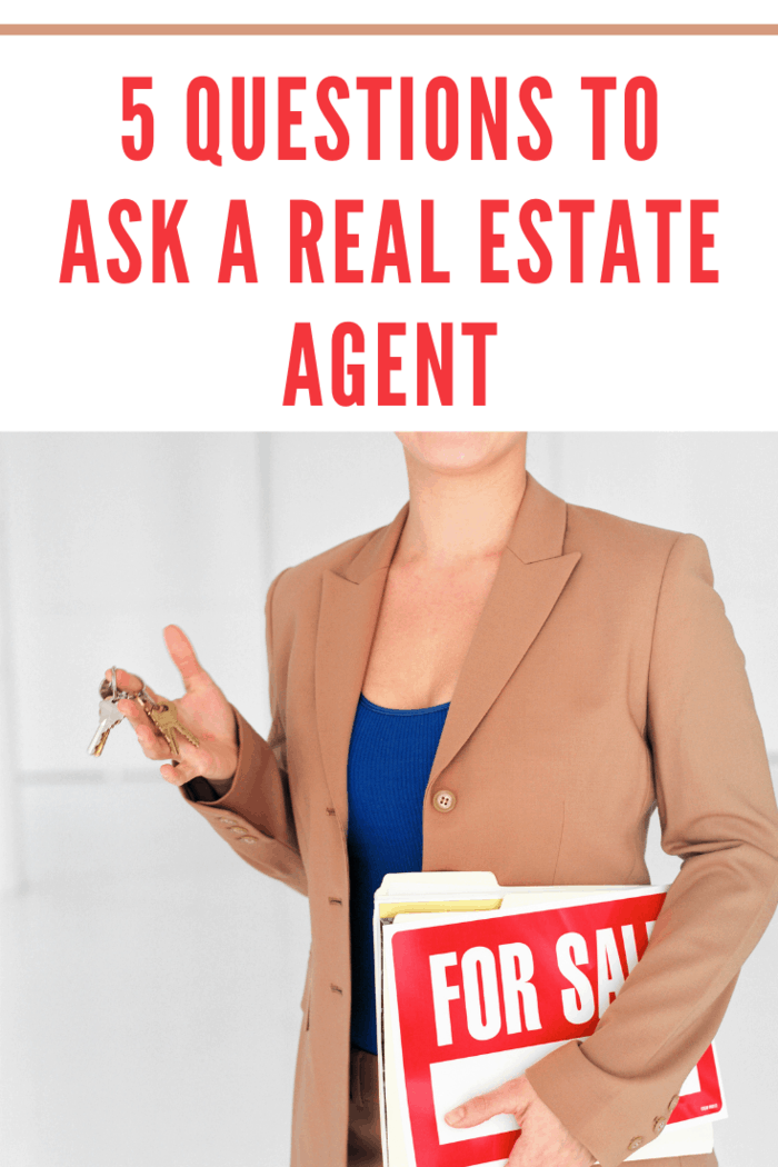 Real estate agent with keys and signs