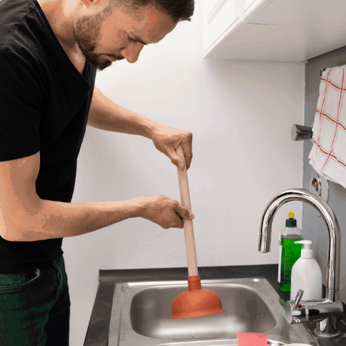 Cleaning Blocked Drain Clog In Kitchen Sink Using Plunger