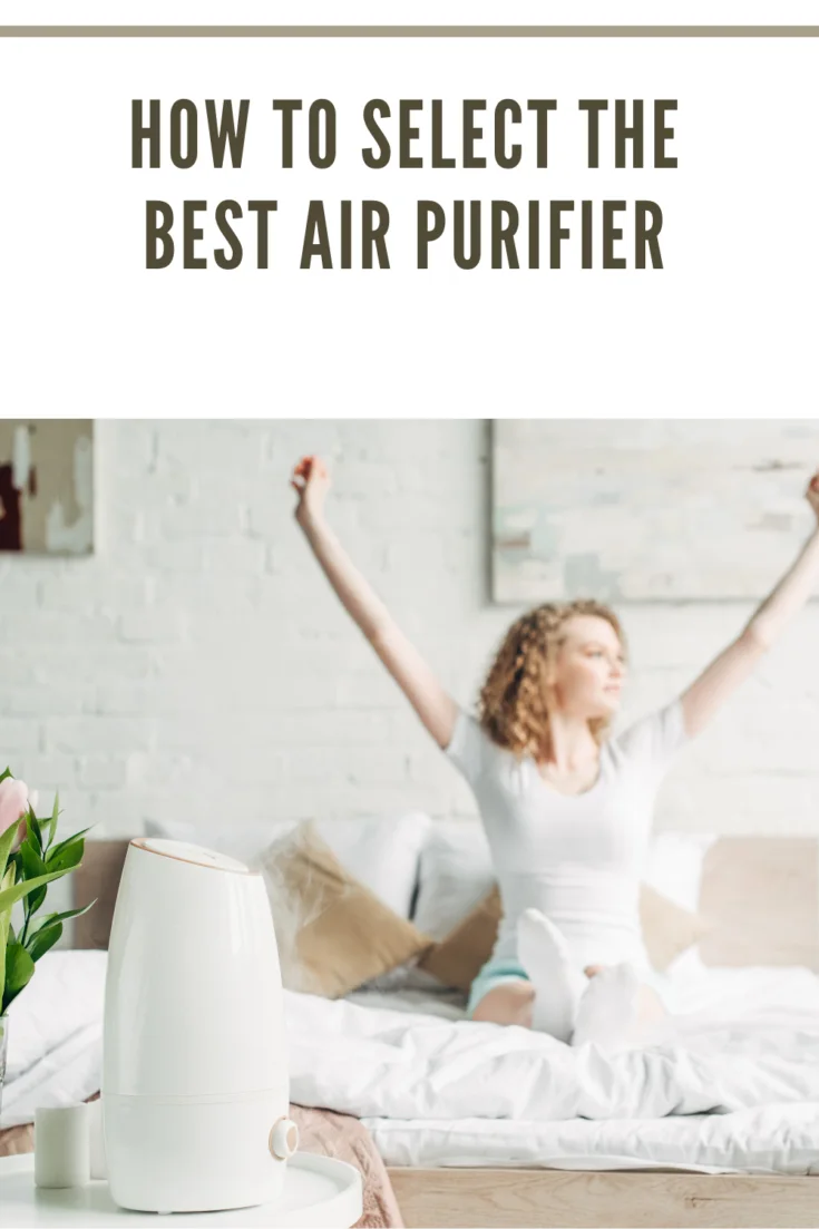 selective focus of happy girl stretching in bedroom with air purifier and tulips