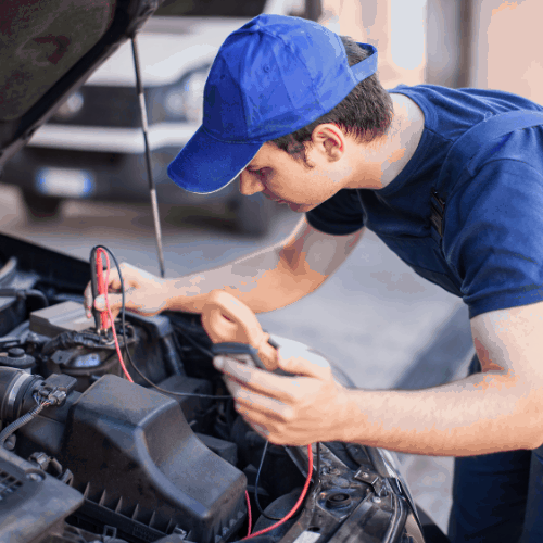 Car electrician troubleshooting a car engine