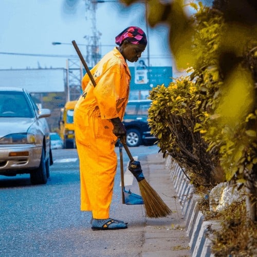 professional cleaning services cleaning curb with broom