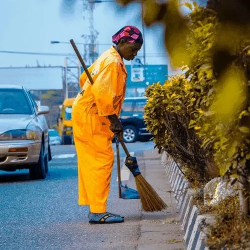 professional cleaning services cleaning curb with broom