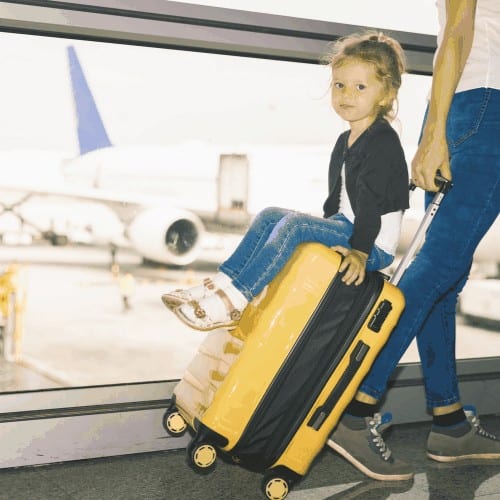 Mom carries your luggage with happy baby at the airport terminal. Flying for holliday, traveling with you luggage safety through Singapore airport. Use businesses class for you comfort