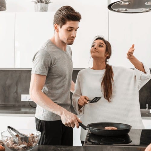 Portrait of an attractive young couple cooking together at the kitchen