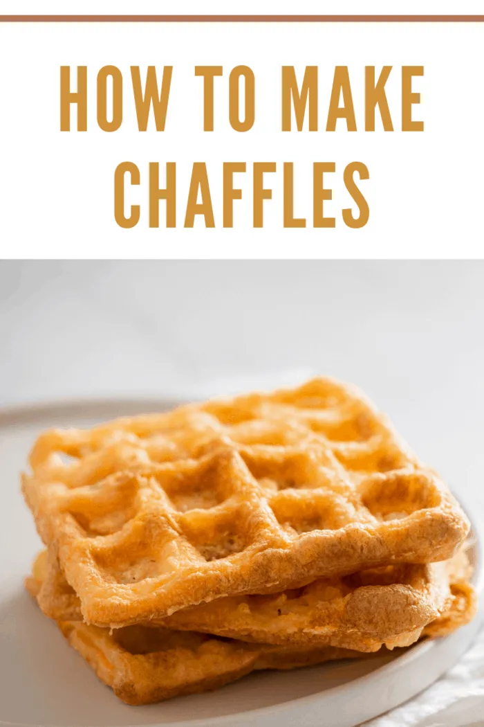 Perfect savory keto waffles. Two ingredients chaffles on plate over white marble background. Eggs and parmesan cheese low carb waffles.