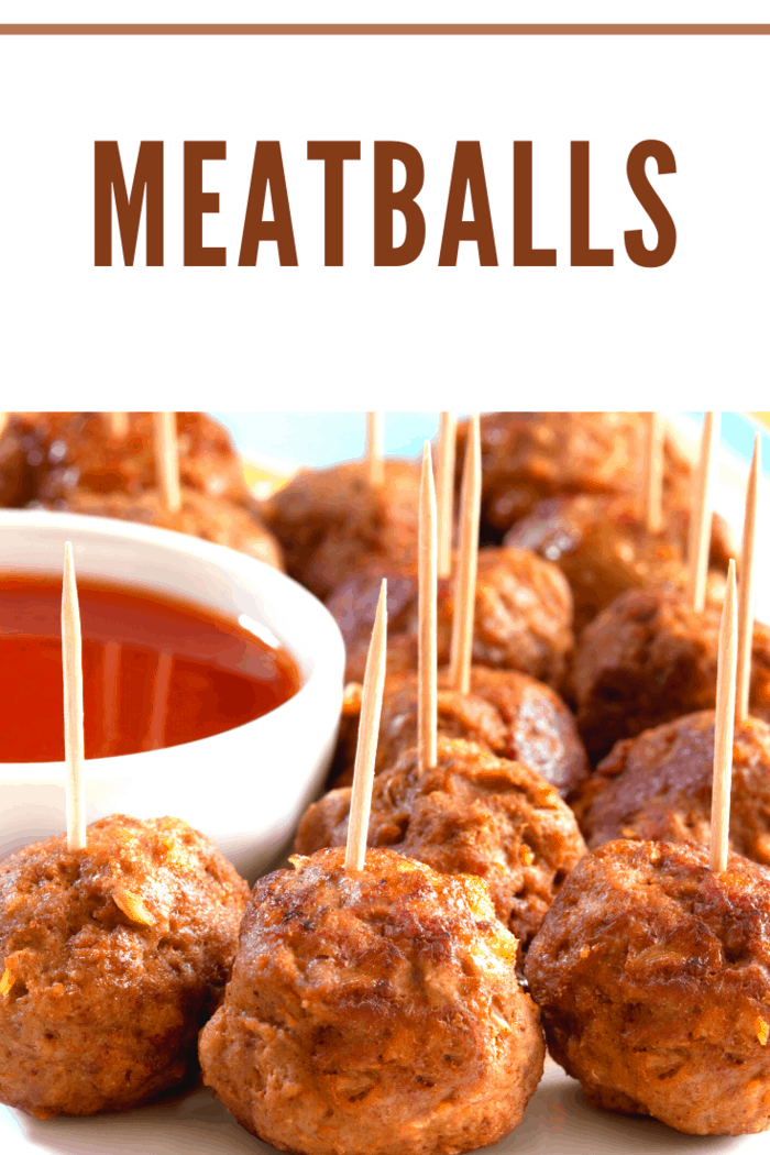 meatballs with toothpicks around dipping sauce