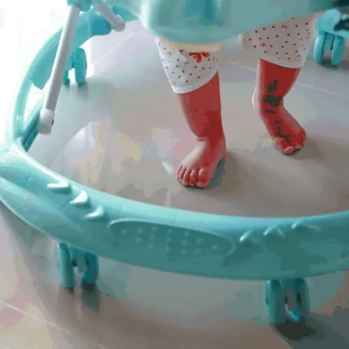 Baby walker closeup with baby legs and feet