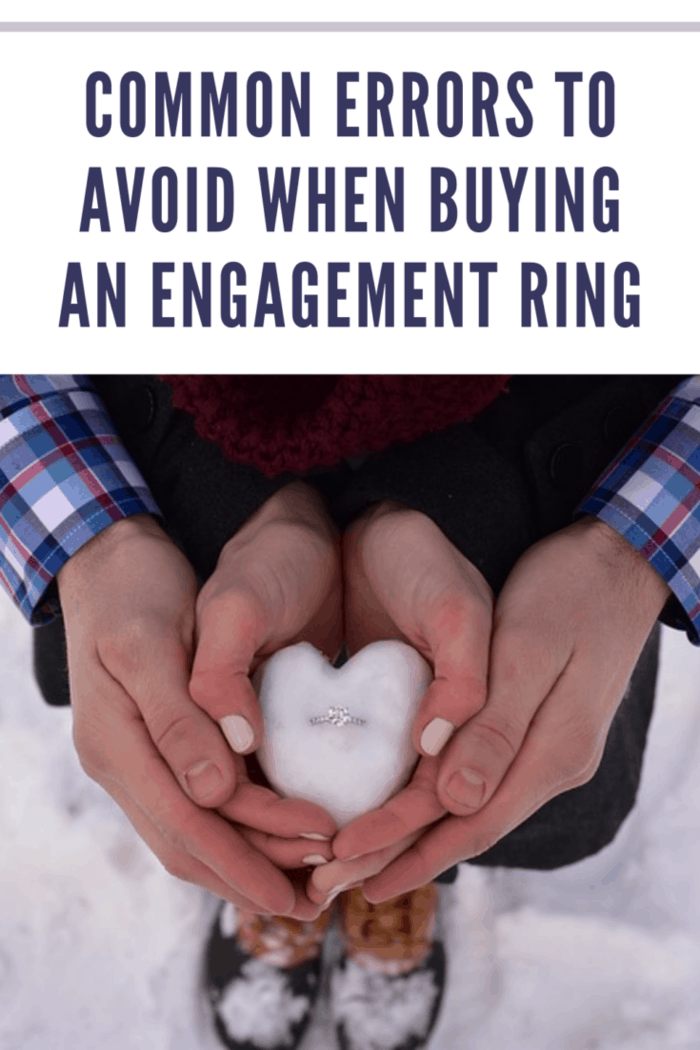 engagement ring in heart shaped snowball being held by couple