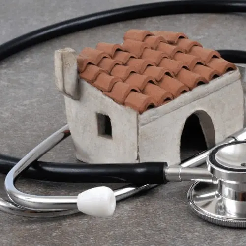 Healthy home concept. Model home with stethoscope around it.