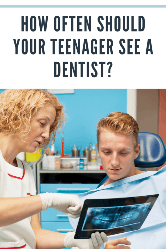 "Portrait of an teenager boy, man, sitting in a dentist chair at dentist office. Selective focus to teenager face, dentist explaining x-ray image to patient."