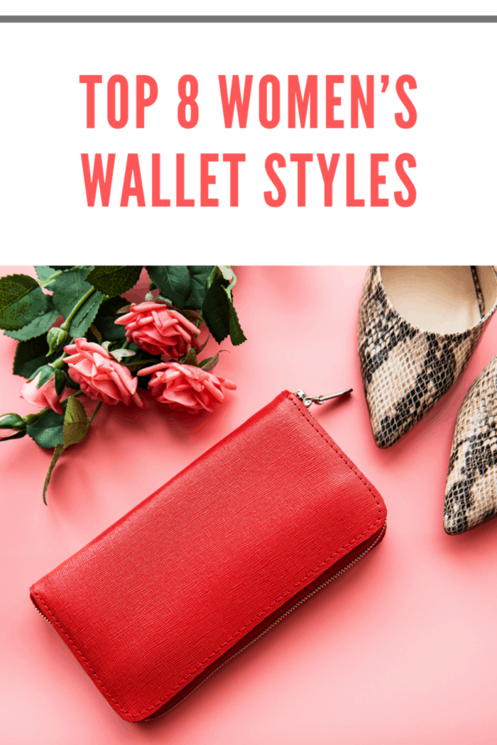 Red leather women wallet, roses and high shoes on pink background