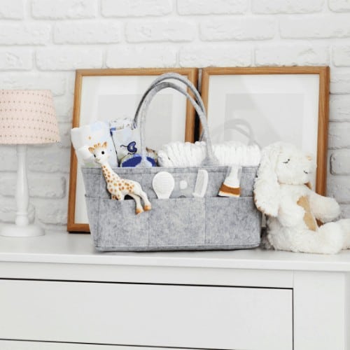 diaper bag with toy, diapers and accessories on white background