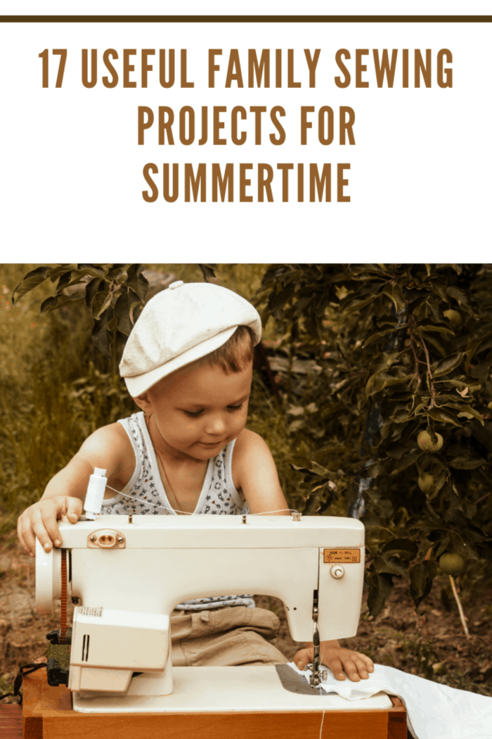 boy sews on the sewing machine in the garden in summer