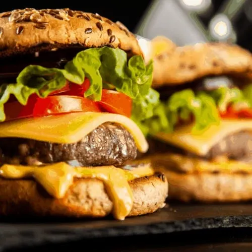 Delicious grilled hamburgers on dark background