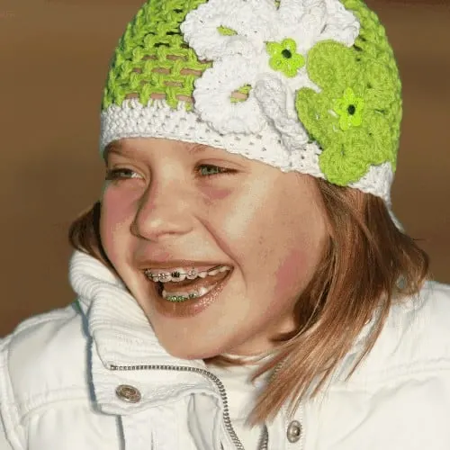 Young girl laughing with braces on her teeth
