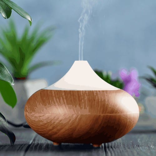 Aroma oil diffuser on wooden table