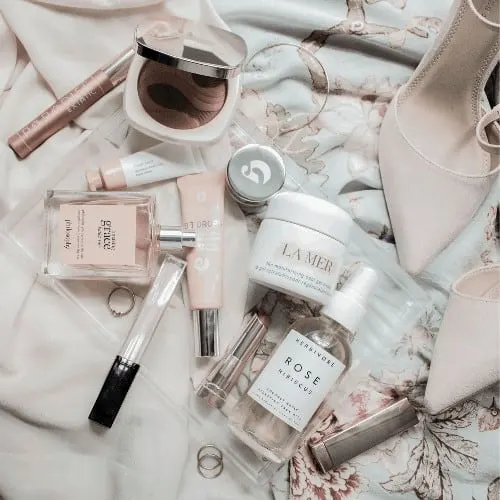 Makeup flatlay of high-end beauty products