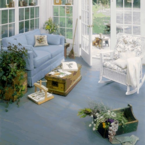 A brightly lit, well propped and cheerful sun room.