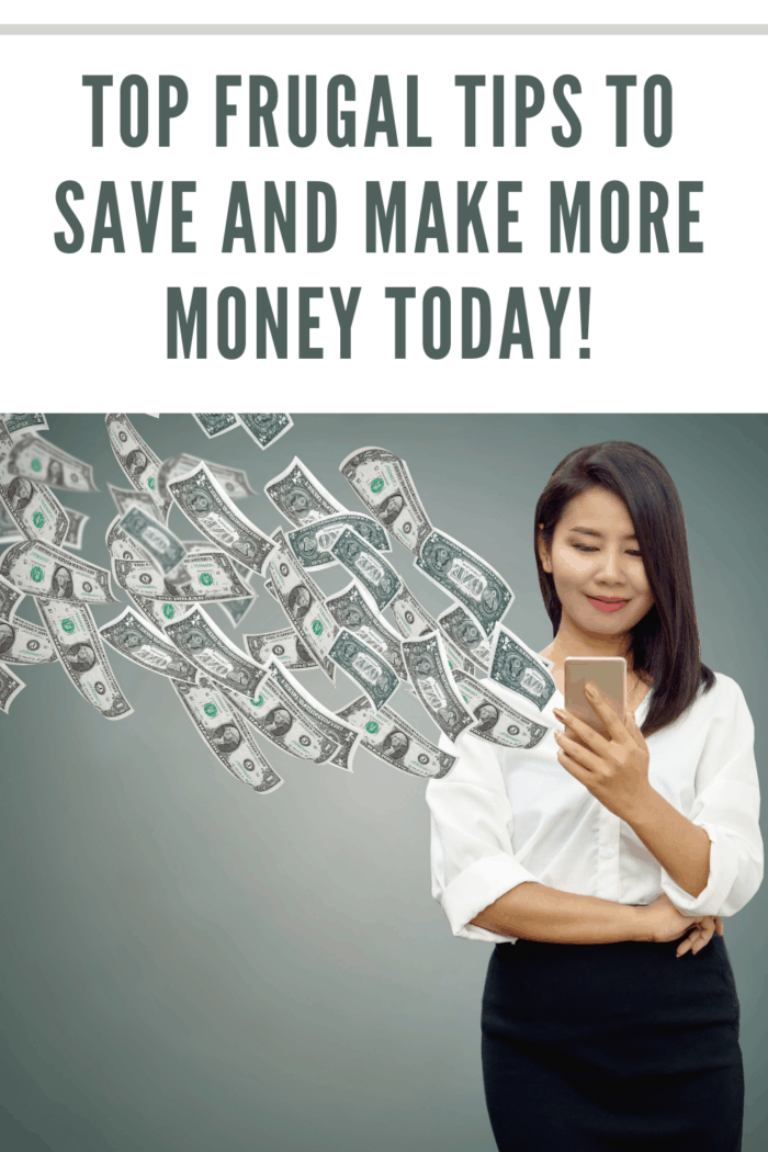 Happy Asian business woman with smart phone in hand making money online with banknotes flying in the air