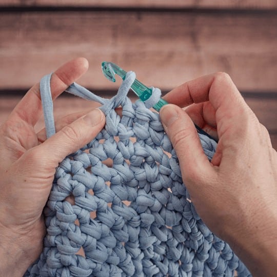 crocheting with blue thick yarn
