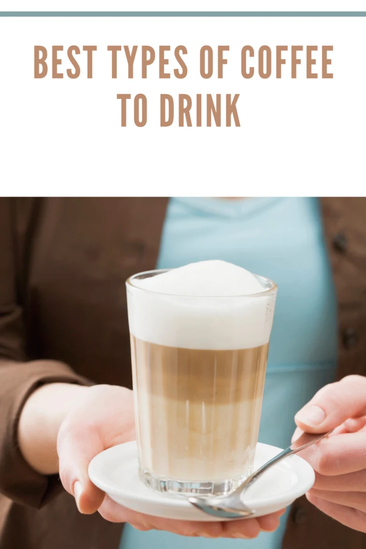 Woman holding a glass of latte macchiato