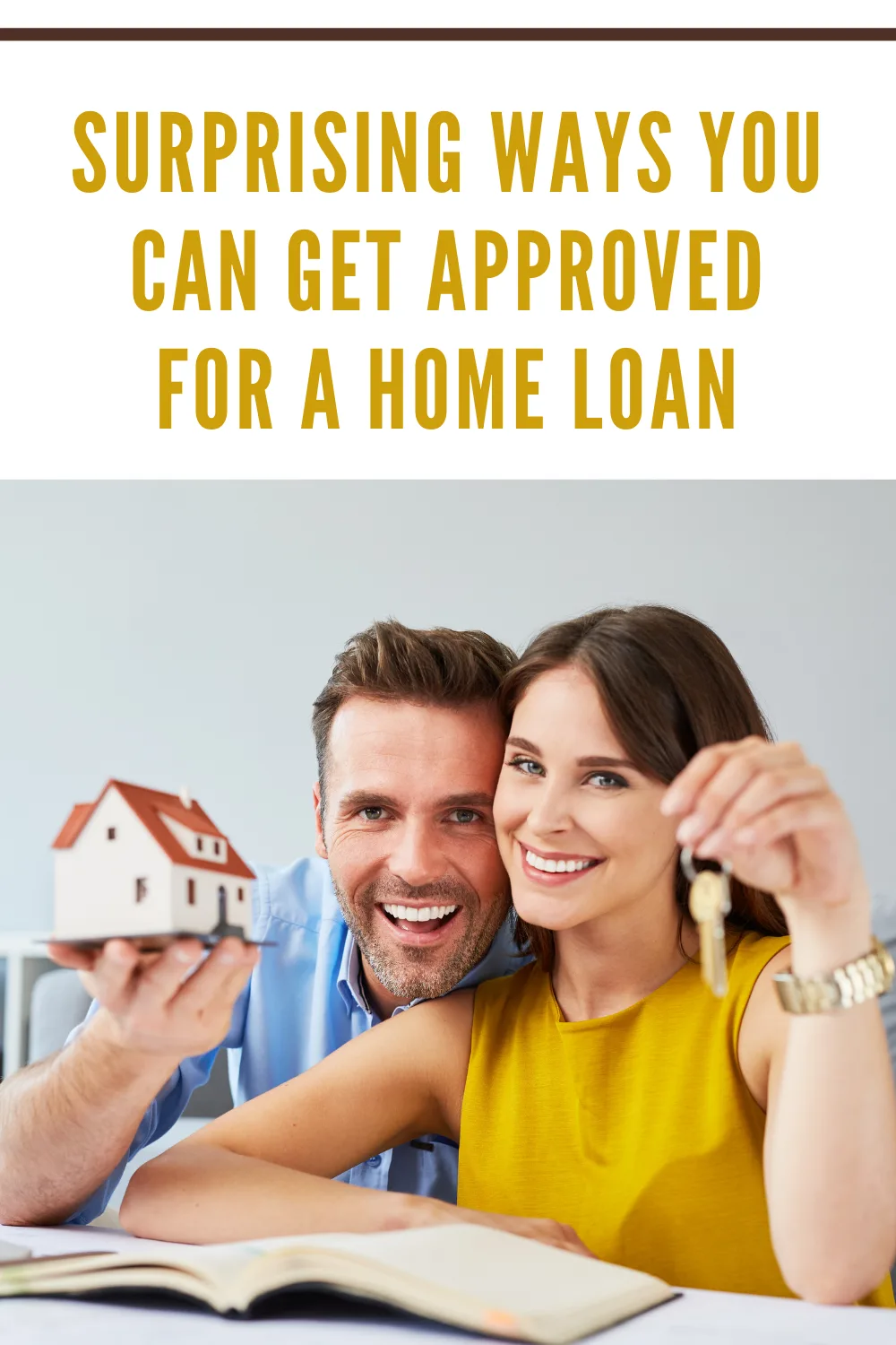 Happy couple holding keys to new home and house miniature - real estate concept