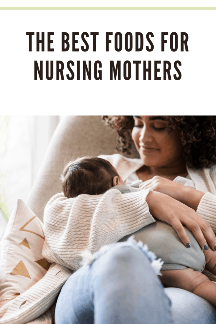 Happy young mom breastfeeds her baby boy while relaxing in their home.