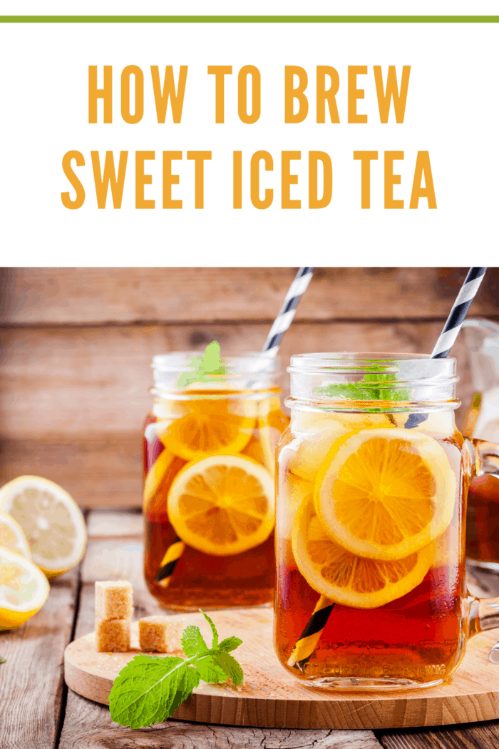 sweet iced tea with slice of lemon in mason jar on the wooden rustic background