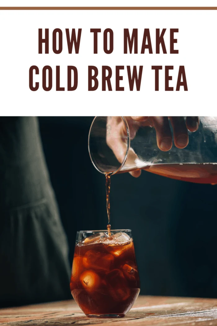 Hands of a barista pouring cold brew tea over ice cubes