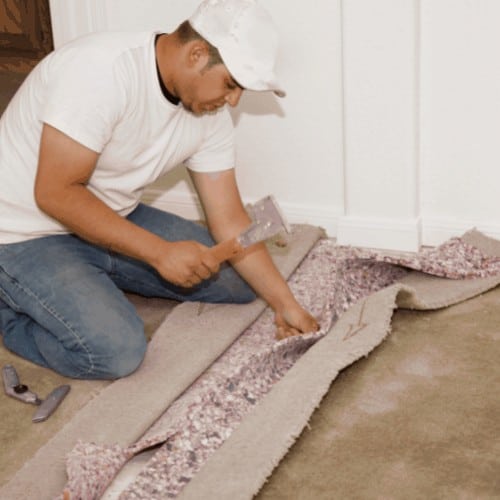 Man Seaming New Carpet Installation