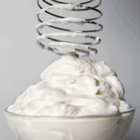 Whipped cream and whisk