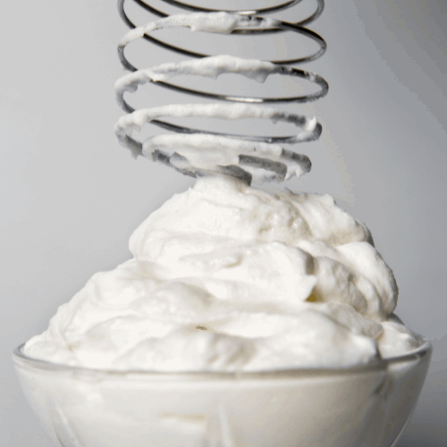 Whipped cream and whisk