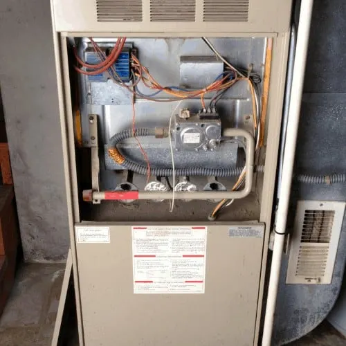 basement home furnace unit with cover off.