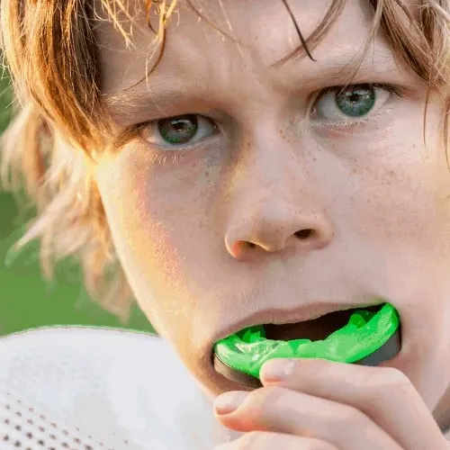 youth playing sports with mouth guard