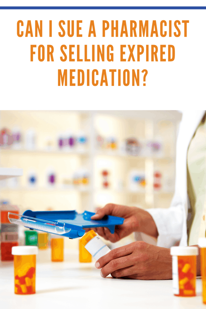 A pharmacist in a white coat using a blue tray to dispense medication in a pharmacy setting.