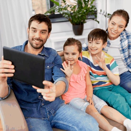 family and people concept - happy father, mother, little son and daughter having video call on tablet pc computer and waving hand at home