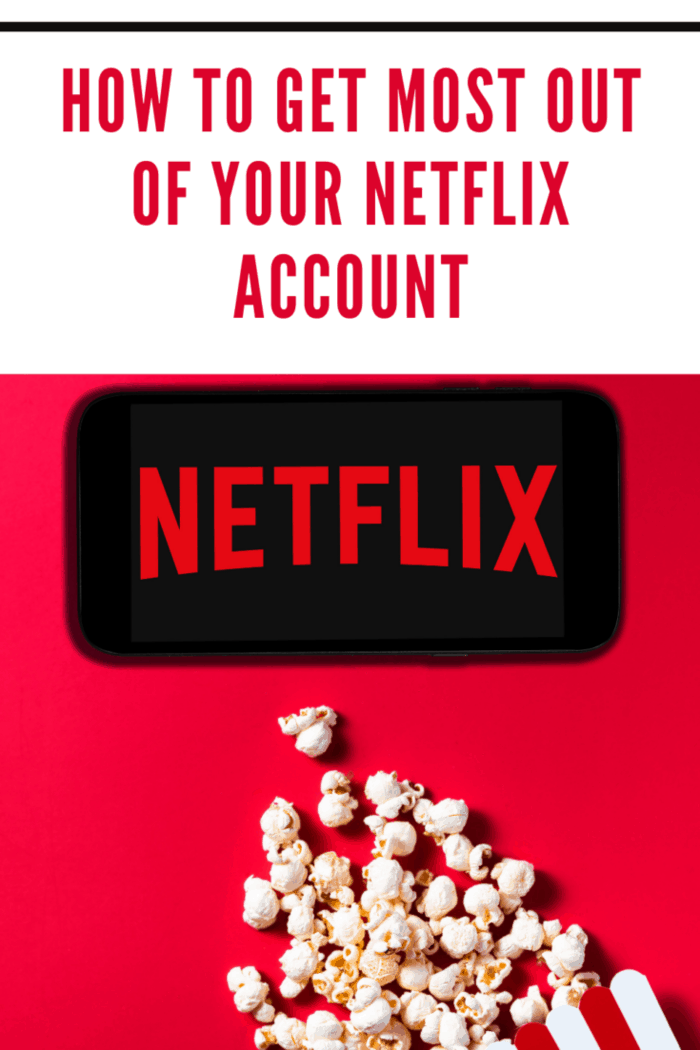 Netflix logo on smartphone with popcorn spilling out of container on red background.