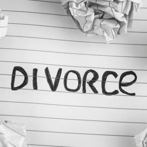 Divorce. Word Divorce On Notebook Sheet With Some Crumpled Paper Balls On It. Close up.