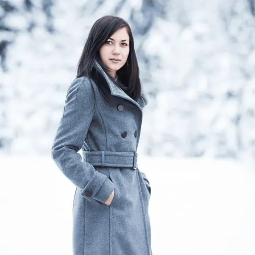 A beautiful young woman in a grey jacket in the winter.