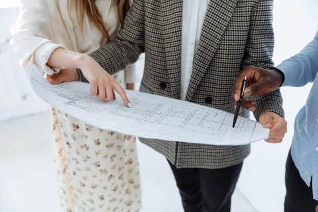 couple looking at blueprints to home