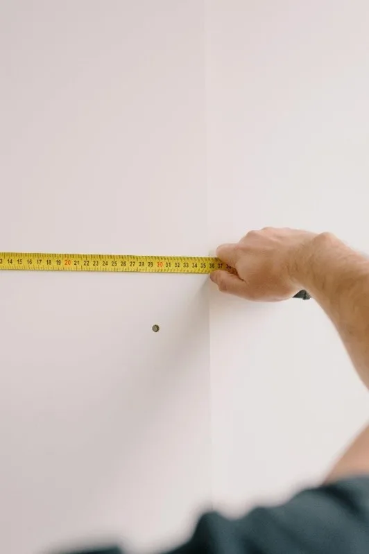 taking measurements of wall
