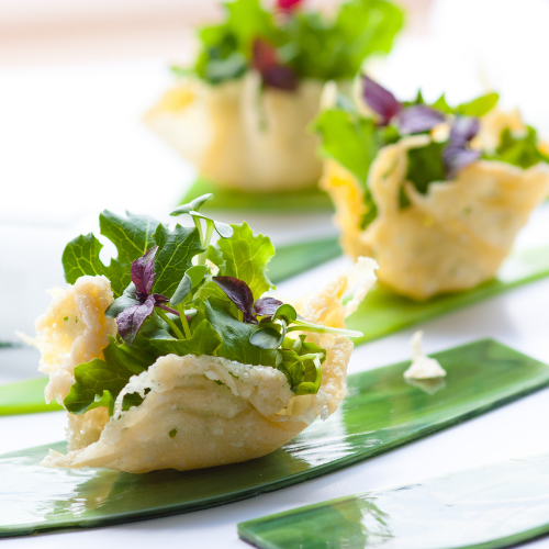three parmesan baskets with baby lettuces