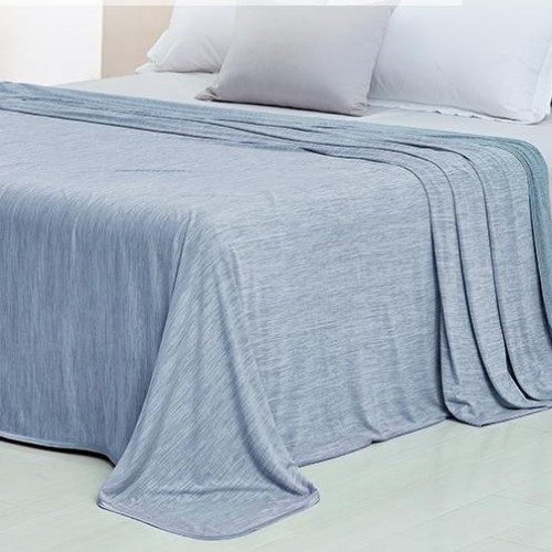 cooling blanket draped on bed