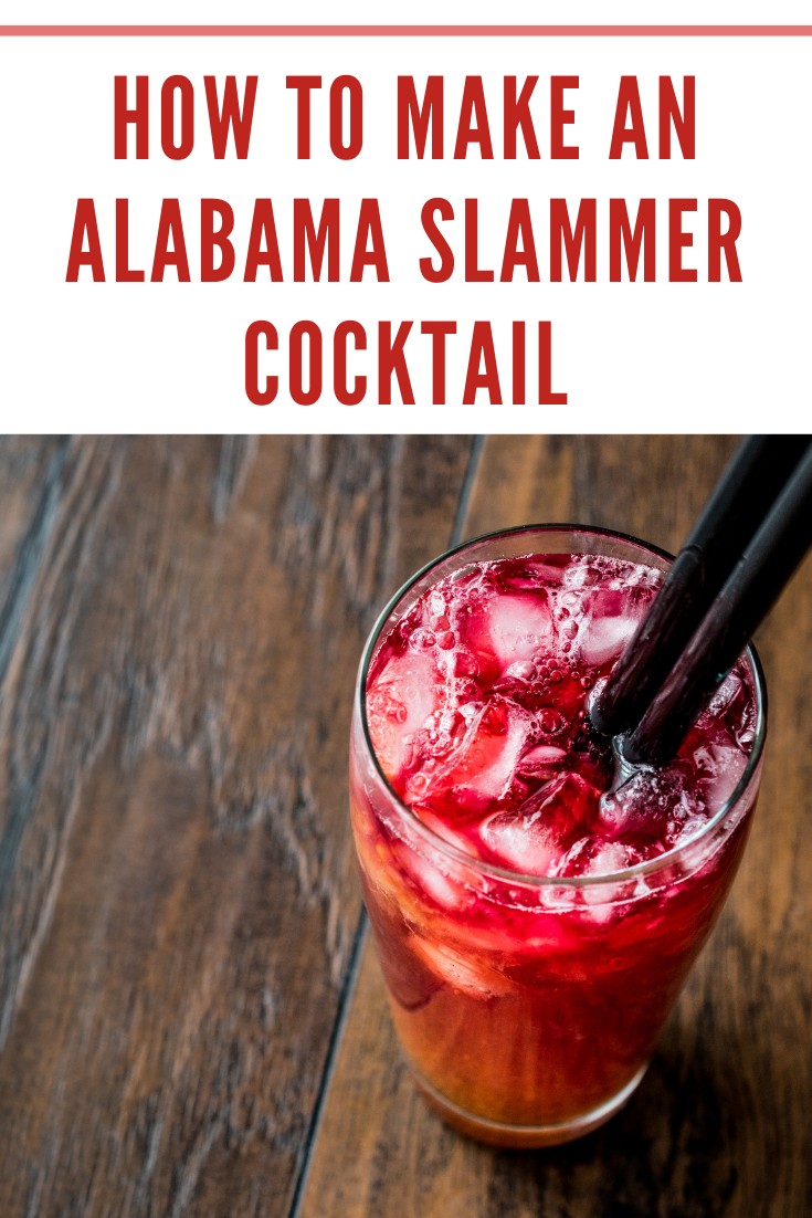 alabama slammer cocktail with black straw overhead view