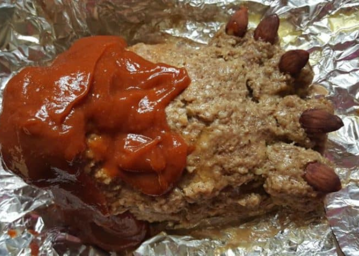 Close-up of more sauce being added to a fully cooked footloaf in the Instant Pot, enhancing the flavor.