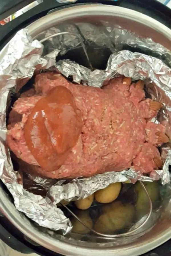 Footloaf with ooey-gooey sauce being added to the Instant Pot, showcasing a flavorful meal.