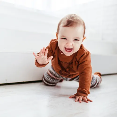 cute baby smiling, crawling and waving