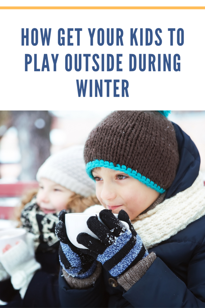 boy in winter clothes holding cup of hot chocolate